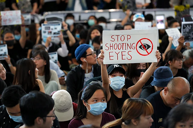 Protesters hold up placard as they take part in a sit-in protest at the arrival hall of the Hong Kong International Airport, a major hub in Asia, in Hong Kong.
