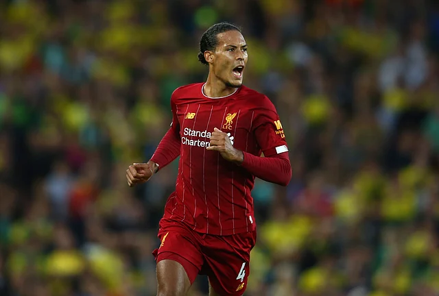 Liverpool’s Virgil van Dijk celebrates after scoring his side’s third goal during the English Premier League soccer match.