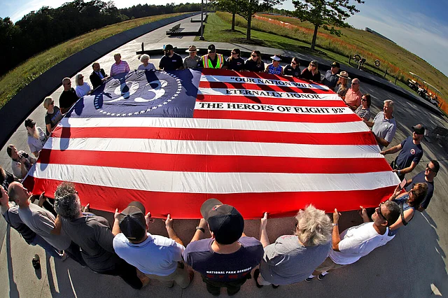Visitors to the Flight 93 National Memorial in Shanksville, participate in a sunset memorial service on Tuesday, 10 September. 