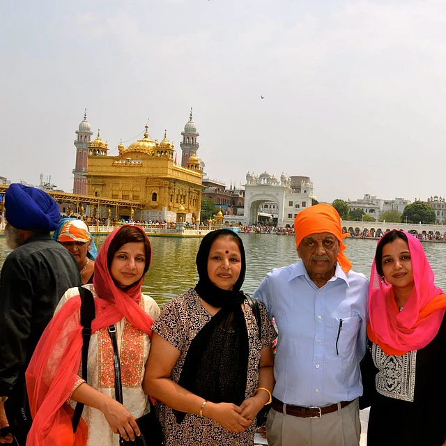 Mr. Menon with his wife and two daughters visiting Golden Temple in 2017.