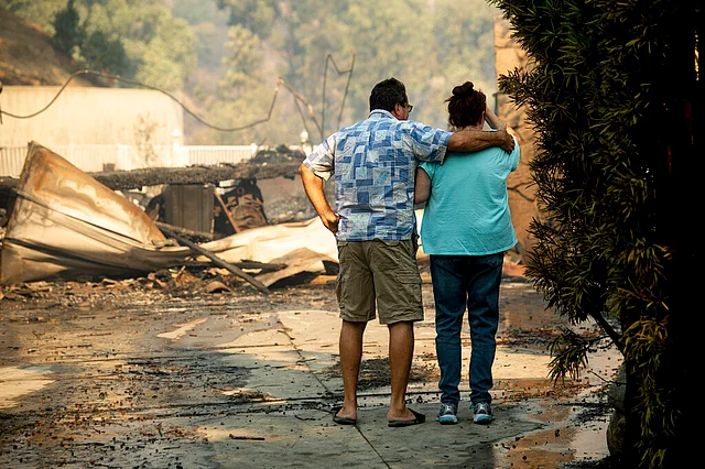 Eyed Jarjour, left, comforts a neighbor who lost her Jolette Ave. home to the Saddleridge Fire.