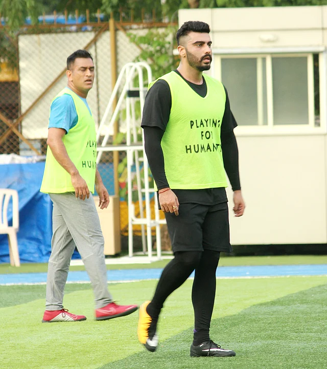 Indian cricketer MS Dhoni and actor Arjun Kapoor during a football match in Mumbai.