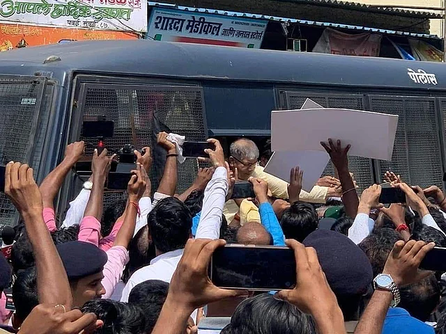 Prakash Ambedkar being taken into custody.