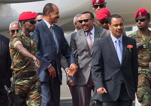 Eritrean President Isaias Afwerki, center left, is welcomed by Ethiopia’s Prime Minister Abiy Ahmed, center right, upon his arrival at Addis Ababa International Airport, Ethiopia. Once official rivals, the leaders of Ethiopia and Eritrea have embraced warmly to the roar of a crowd of thousands at a concert celebrating the end of a long state of war.