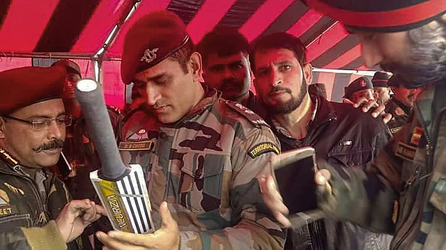 MS Dhoni in his Army uniform, signing a bat in Srinagar.