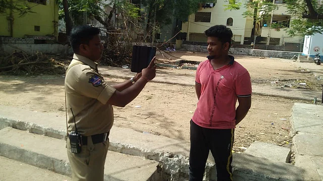Police personnel taking pictures of residents to find a few criminals in the city.