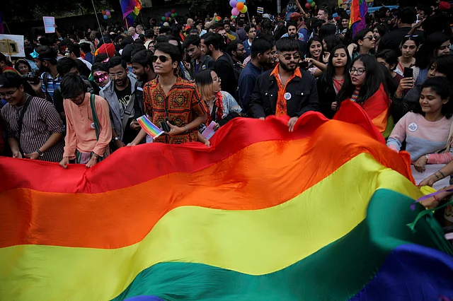 Members of the LGBTQ community and their supporters display a rainbow flag during the annual Delhi Queer Pride parade in Delhi, India on Sunday.