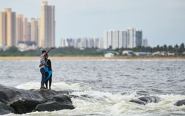 A young couple takes selfie off the shores of Bay of Bengal in the backdrop of high-rise residential units off East Coast Road in Chennai.
