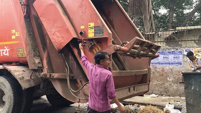 A worker clears garbage inRK Puram area.