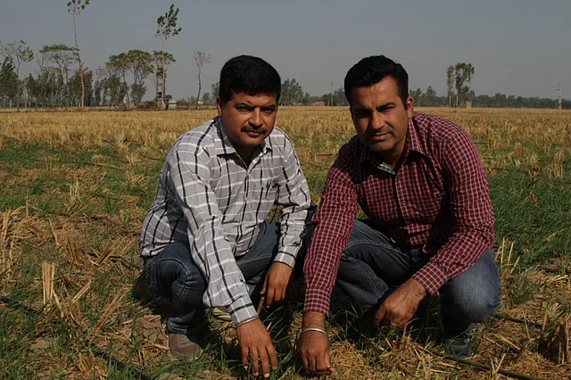 Manoj Kumar and Vikas Chaudhary in their field in Karnal.