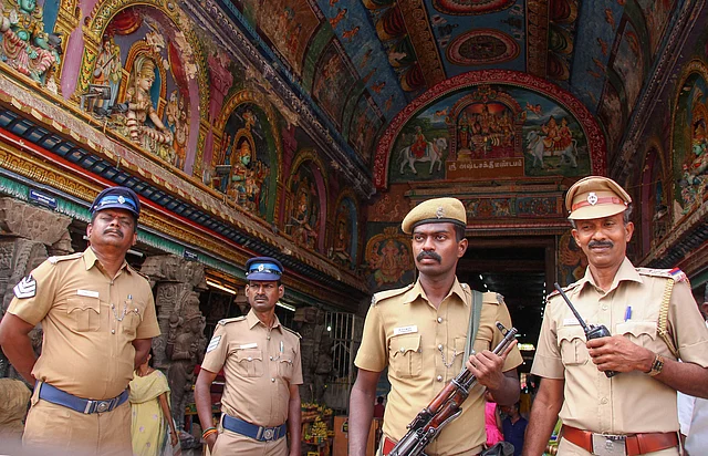Police personnel inspect the premises of Meenakshi Sundareswarar Temple in view of the Babri Masjid demolition anniversary, in Madurai on Thursday.