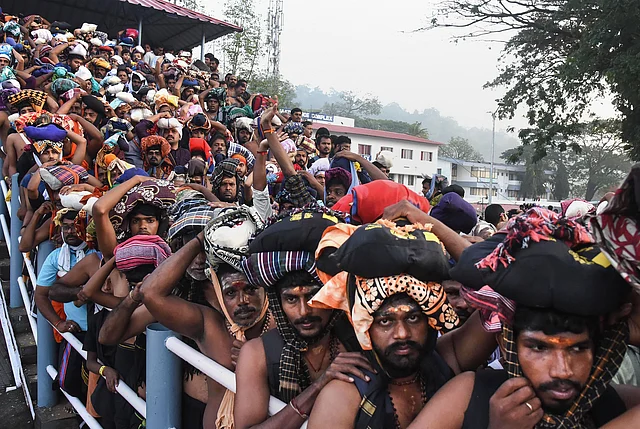 Devotees stand in queues to offer prayers at the Lord Ayyappa temple in Sabarimala on Monday.