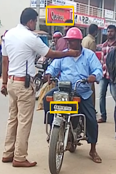 The number plate and shop’s banner highlighted in yellow.