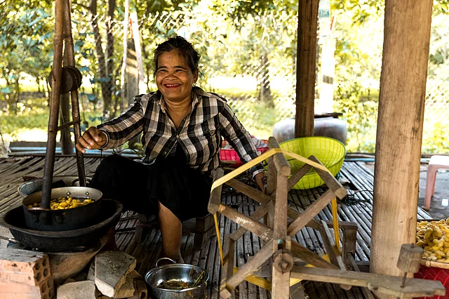 A lady boiling silkworms and extracting the silk from them