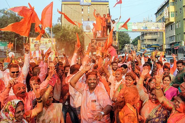 Shiv Sena supporters celebrate after their party chief Uddhav Thackeray was designated as Maharashtra’s new CM.