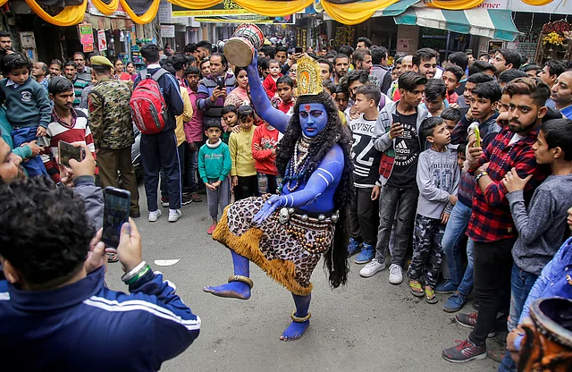 A devotee dressed as Lord Shiva dances during a procession on the occasion of Kal Bahirav Ashtmi in Jammu on Wednesday.
