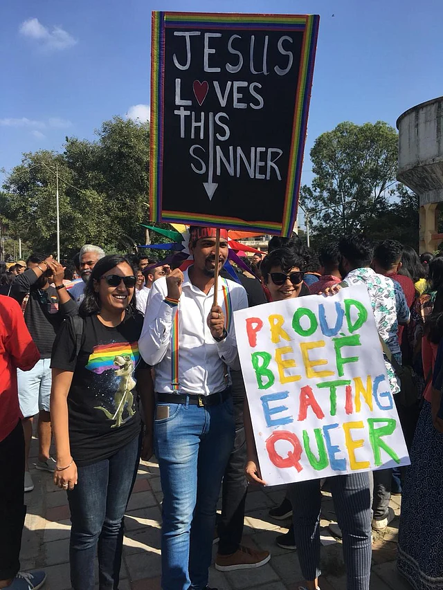 Protesters hold placards calling for social acceptance. 