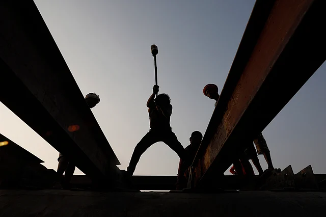 Indian laborers build a pontoon bridge in the river Ganges for the upcoming Magh Mela festival, in Prayagraj, India, Thursday, 28 November 2019.