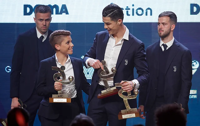 Juventus’ Cristiano Ronaldo, right, and Manuela Giugliano pose with the trophy for best Italian Serie A player, during the Gran Gala’ soccer awards ceremony.