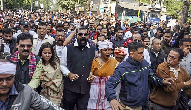 All Assam Students Union (AASU) Chief Advisor Samujjal Bhattacharya along with artists and others raises slogans. 