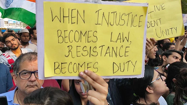 Protesters raise placards inside Mumbai University.