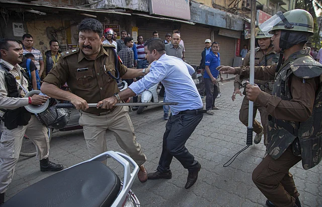 Policemen detain a protestor demonstrating against the Citizenship Amendment Bill (CAB) in Guwahati. 