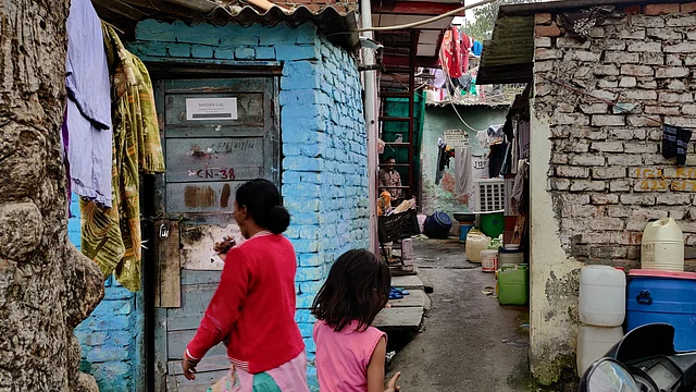Residents go about their daily business outside the slum.