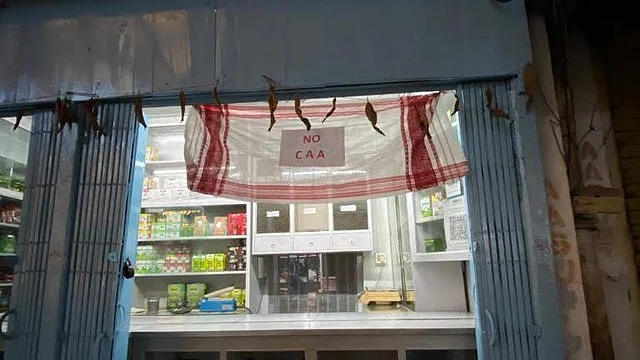 A shop in Assam’s Tezpur with a Gamosa as an anti-CAA banner.