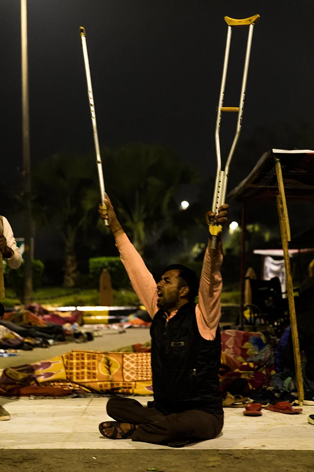 A protester raises his creches as he shouts slogans demanding a job. 