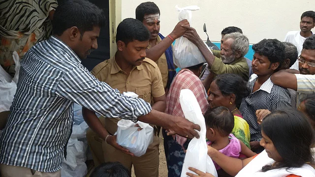 Refugees being handed rations at the camp.