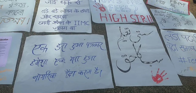 'How's the fees? High sir!' a poster reads.