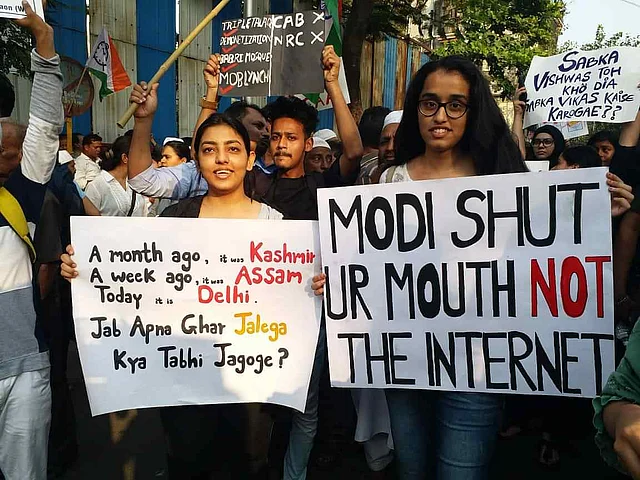 Protesters hold witty posters. 