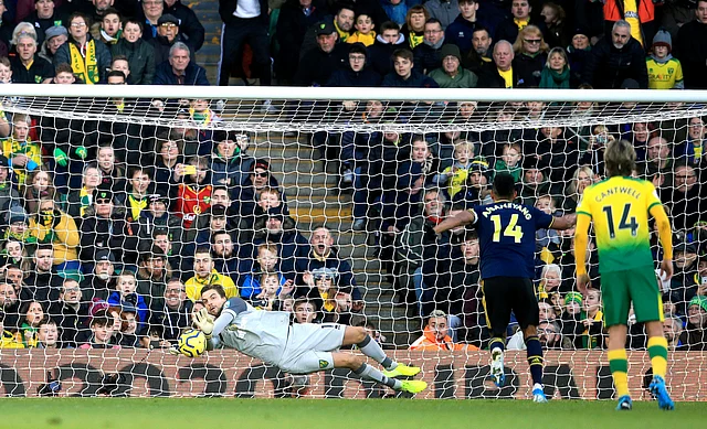 Norwich City goalkeeper Tim Krul, left, saves a penalty shot from Arsenal’s Pierre-Emerick Aubameyang, second right, during their English Premier League match at Carrow Road in Norwich, England.
