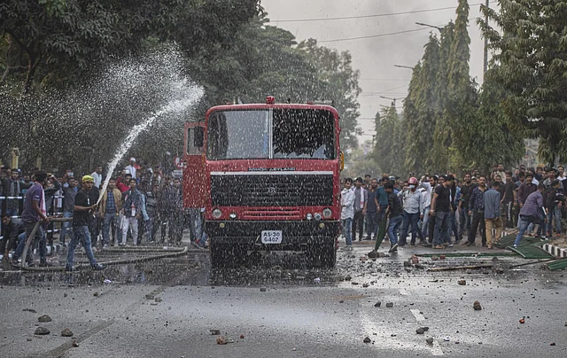 Indian protesters vandalise a fire engine during a protest against the Citizenship Amendment Bill (CAB) in Guwahati.
