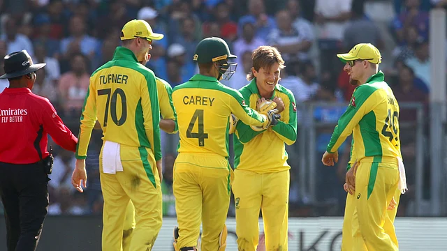 Australian players celebrate the wicket of Virat Kohli with bowler Adam Zampa. 