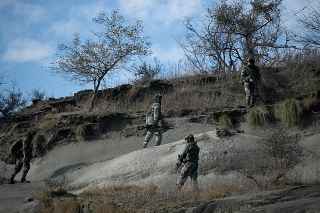 Security force soldiers near the site of a gunbattle at Nagrota, on the outskirts of Jammu, on Friday, 31 January.