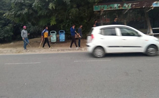 A group of men, including Mandal, can be seen entering the JNU campus with lathis.