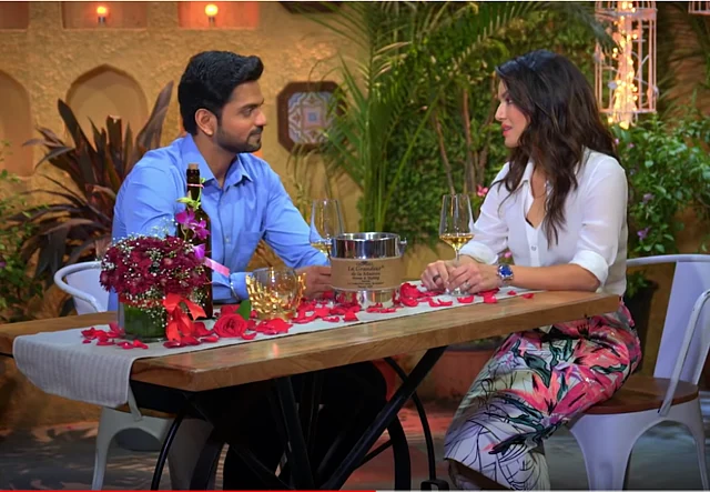 Sunny Leone in conversation with a contestant.