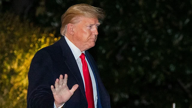 US President Donald Trump waves as he leaves the White House.