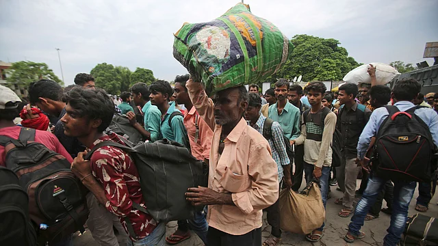 Indian migrant labourers carry their luggage and prepare to leave the region, at a railway station in Jammu. Image used for representational purposes. 