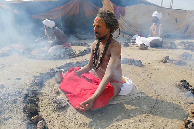 Hindu monks burn dried cow dung cakes as they perform a ritual at the Sangam, the confluence of rivers Ganges and Yamuna, on Basant Panchami day at the annual traditional fair of Magh Mela Prayagraj, on Thursday, 30 January.