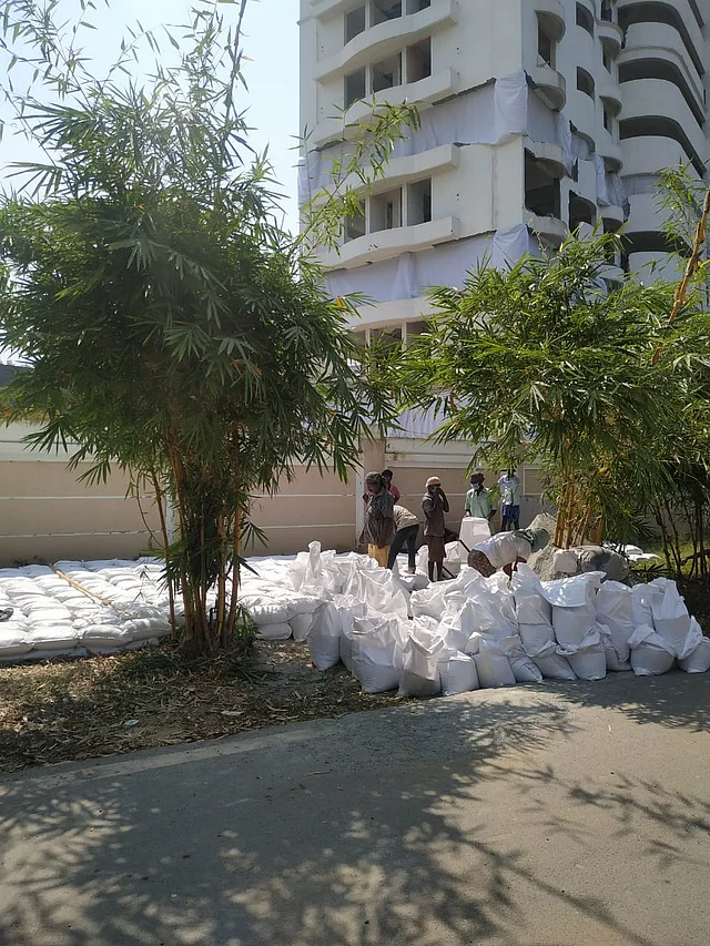 Workers fill sandbags that are to be placed over oil pipelines in the area. 