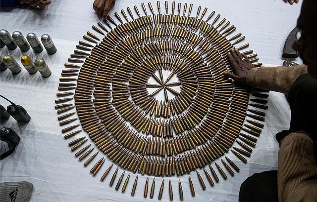 Assam police personnel display bullets during an arms laying ceremony by cadres of National Democratic Front of Bodoland (NDFB) in Guwahati on Thursday, 30 January.
