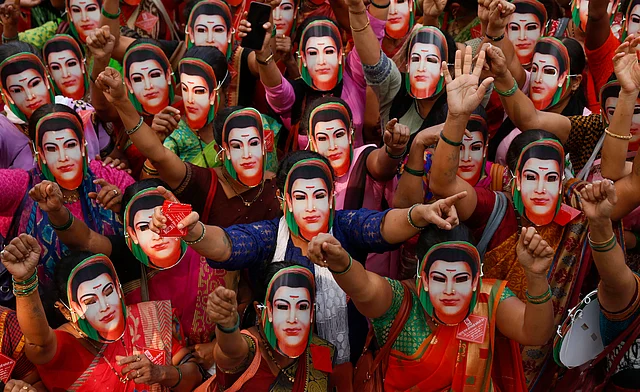 Anganwadi workers wear the mask of social activist Savitribai Phule to mark her birth anniversary, during a protest for their various demands at the Collectors Office, in Thane, Friday, 3 Jan 2020.