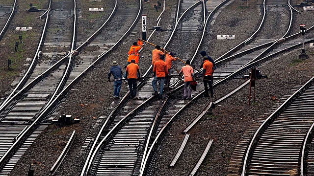 Indian railway workers inspect the tracks on a cold winter morning in Guwahati, India, Friday, 3 Jan 2020.