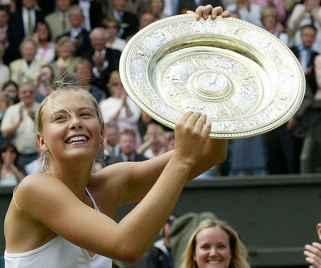 In this July 3, 2004, file photo, Russia’s Maria Sharapova holds the winner’s trophy after defeating Serena Williams in the Women’s Singles final match on the Centre Court at Wimbledon. 