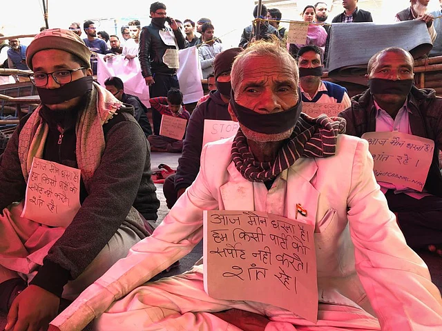 Men at the sit-in in Shaheen Bagh wearing black bands as a mark of silent protest.