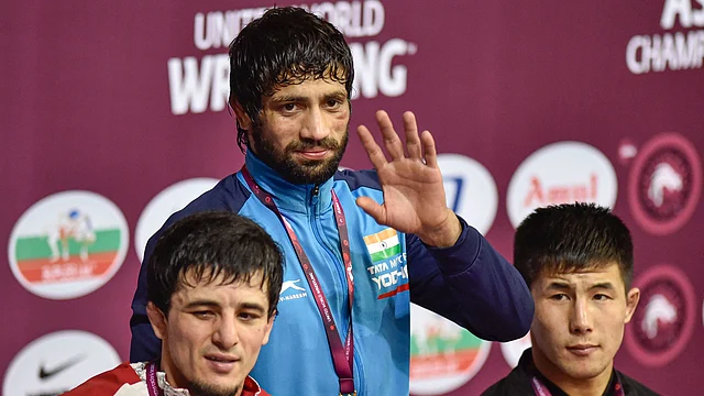 Ravi Dahiya with his gold medal at the podium.