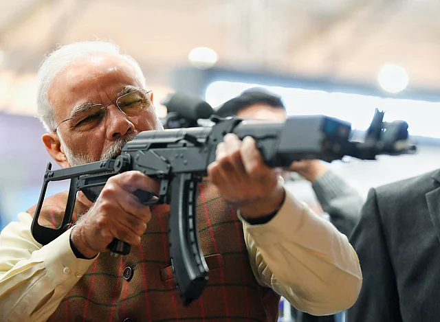 Prime Minister Narendra Modi tries a weapon during the inauguration of 11th edition of DefExpo 2020, in Lucknow, Wednesday, 5 February 2020. 