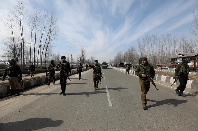 Army jawans take positions during an encounter with the militants on the Srinagar-Baramulla National Highway, near Srinagar, Wednesday, 5 February. Two militants and a CRPF jawan were killed in the encounter and one militant was arrested alive in injured condition.